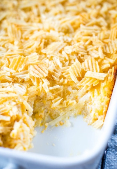slice out of cheesy hashbrown casserole in pan