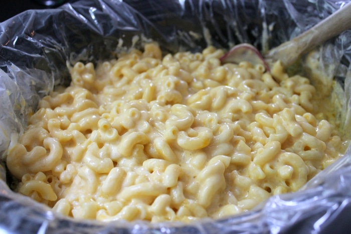 simple mac and cheese recipe with spoon in crock pot