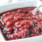 cranberry sauce in white bowl with spoon
