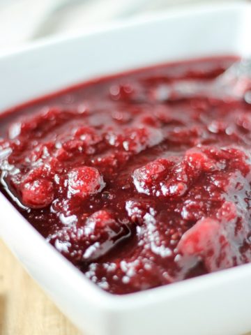 cranberry sauce in white bowl with spoon
