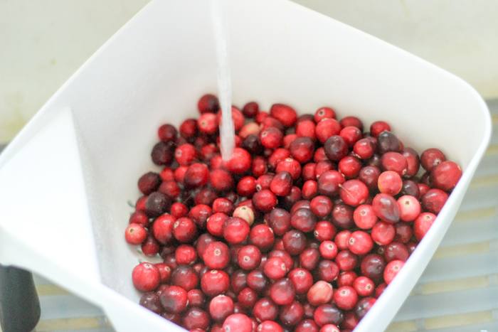 fresh cranberries being washed with water