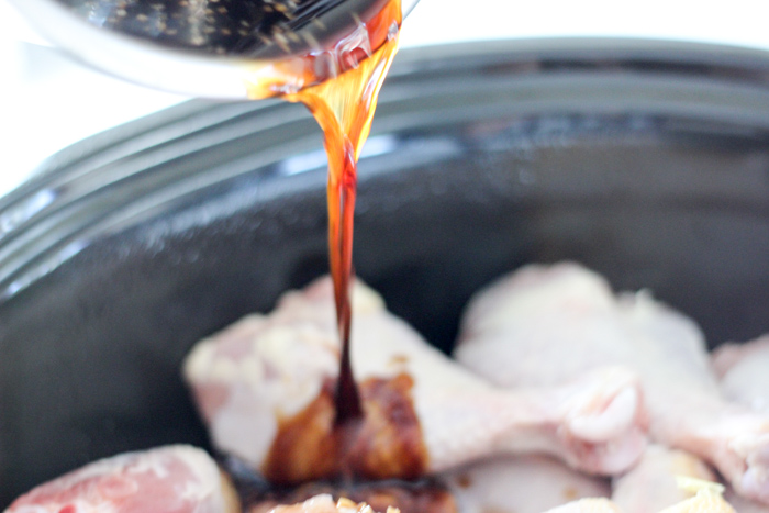 pouring sticky and sweet sauce on raw drumsticks