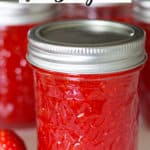 strawberry freezer jam in jar with strawberry
