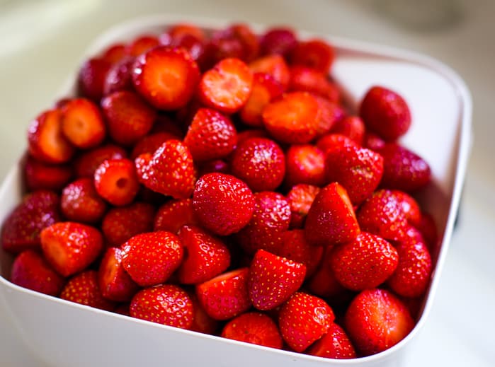 cut strawberries in colander