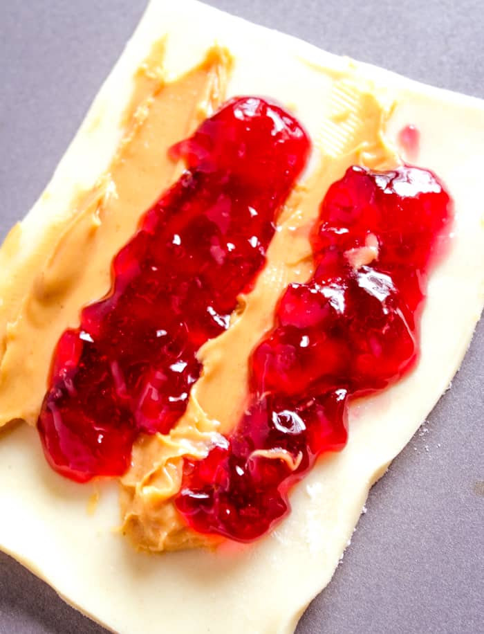peanut butter and jelly on pie crust to make the homemade pop tart