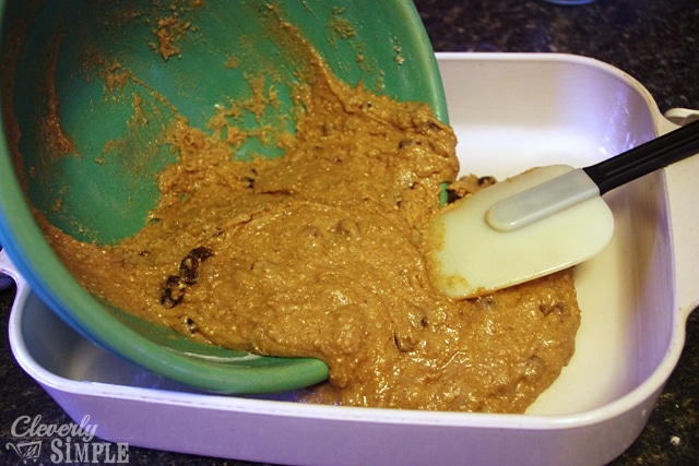 pouring raisin cake batter into pan