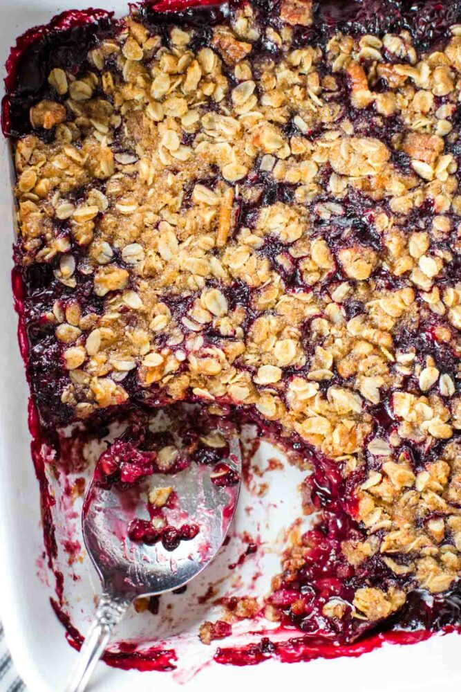 blackberry crumble in baking pan with spoon