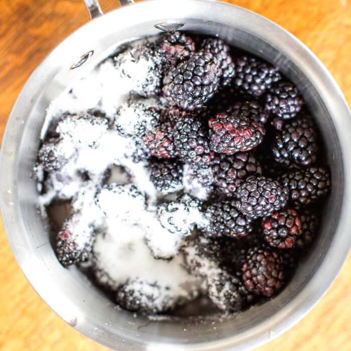 fresh blackberries with sugar in stock pot