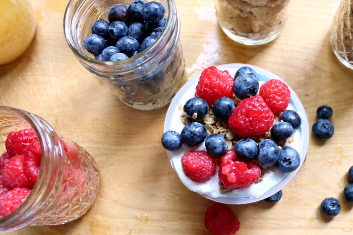 strawberries and blueberries on yogurt