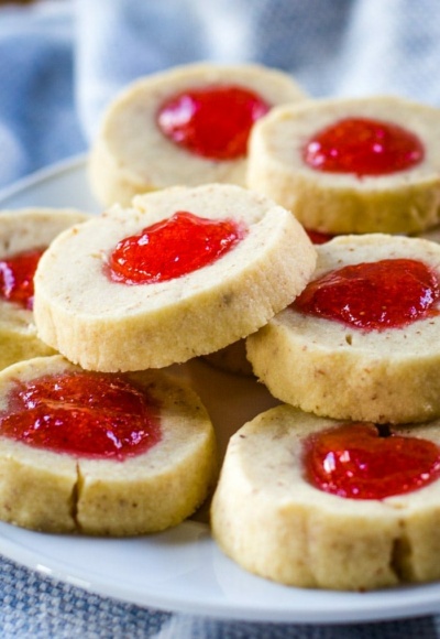 almond thumbprint cookies with strawberry jelly on plate
