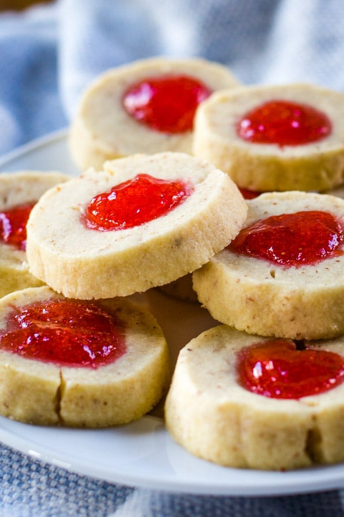 almond thumbprint cookies with strawberry jelly on plate