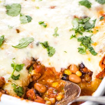 mexican casserole in baking dish with scoop taken out