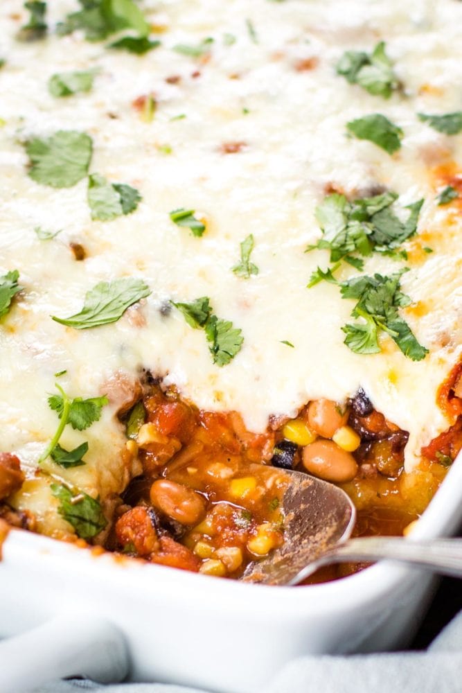 mexican casserole in baking dish with scoop taken out