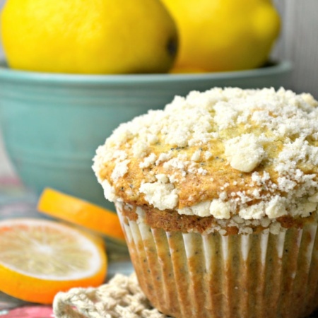 poppy seed muffin on napkin with lemons in the background