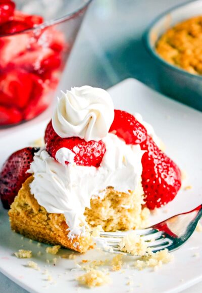 strawberry shortcake with whipped cream and strawberries on plate