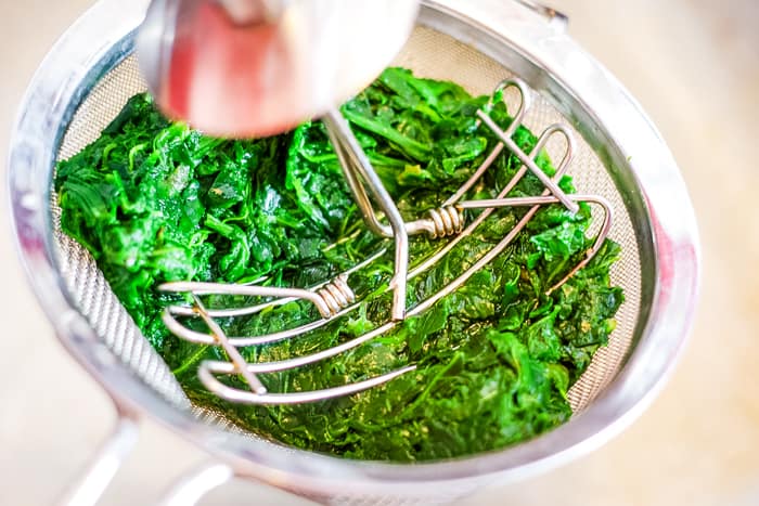 draining spinach in colander