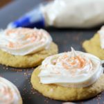 pumpkin cookies with cream cheese frosting bag in background
