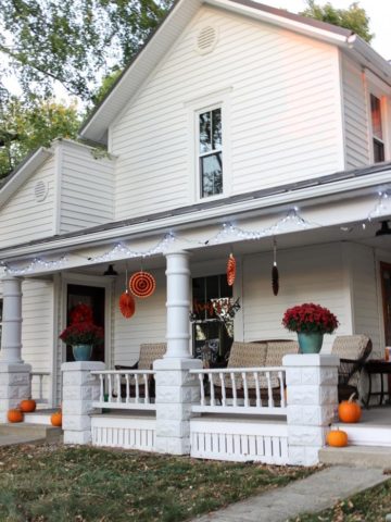 white farmhouse porch with halloween fall decorations