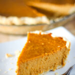 slice of pumpkin pie on plate with fork