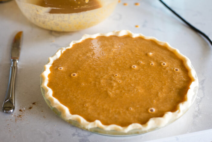 pumpkin pie filling in pie shell unbaked