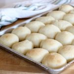 fresh baked dinner rolls on baking sheet