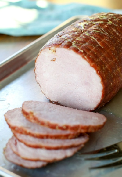 Sliced ham on metal baking sheet