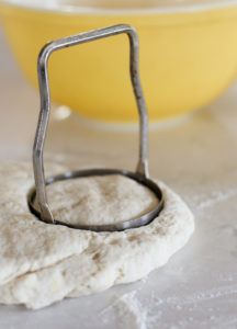 biscuit cutter in biscuit dough