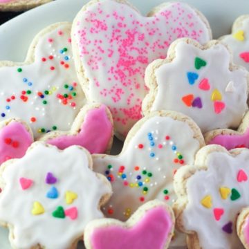 plate of sugar cookies with icing and sprinkles