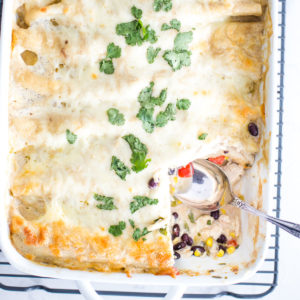 slice of chicken enchiladas out of pan