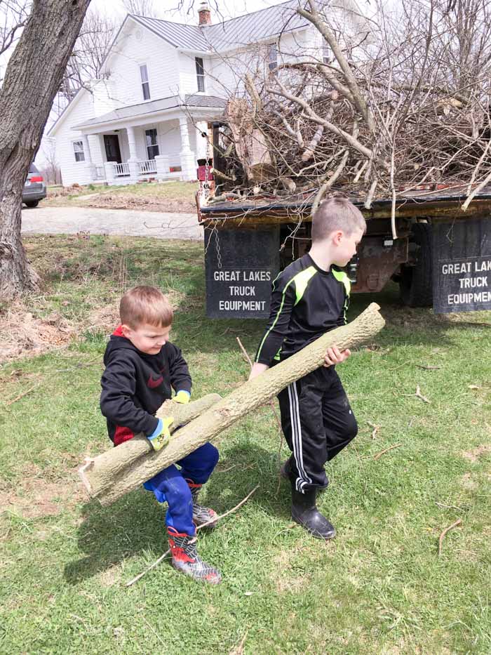 boys working to clean up yard