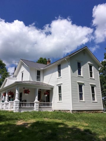 white farmhouse in Ohio on hill