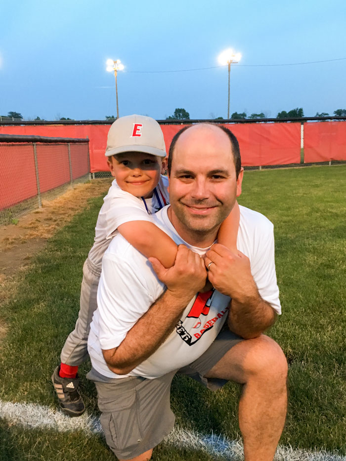 dad and son on baseball field