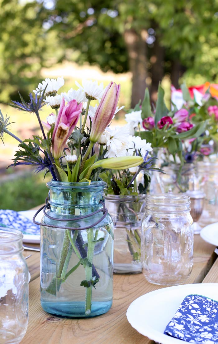 ball jars with flowers on picnic table
