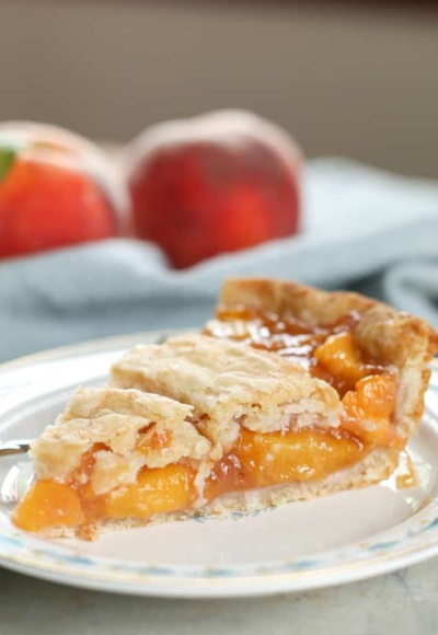 peach pie on plate with peaches