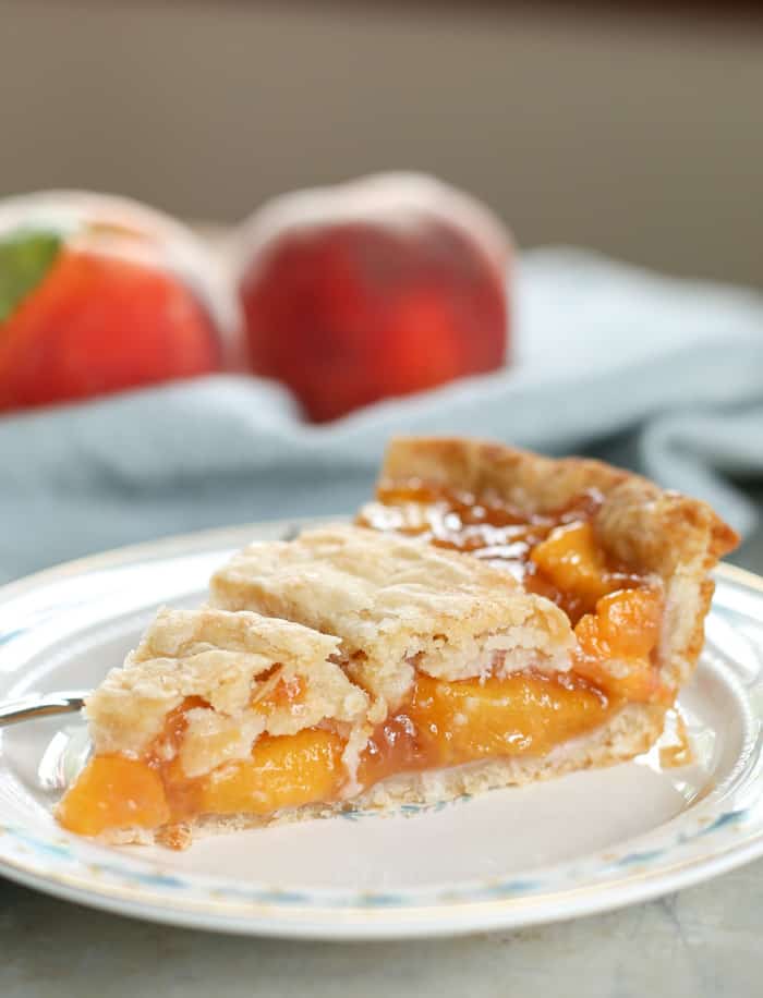 peach pie on plate with peaches