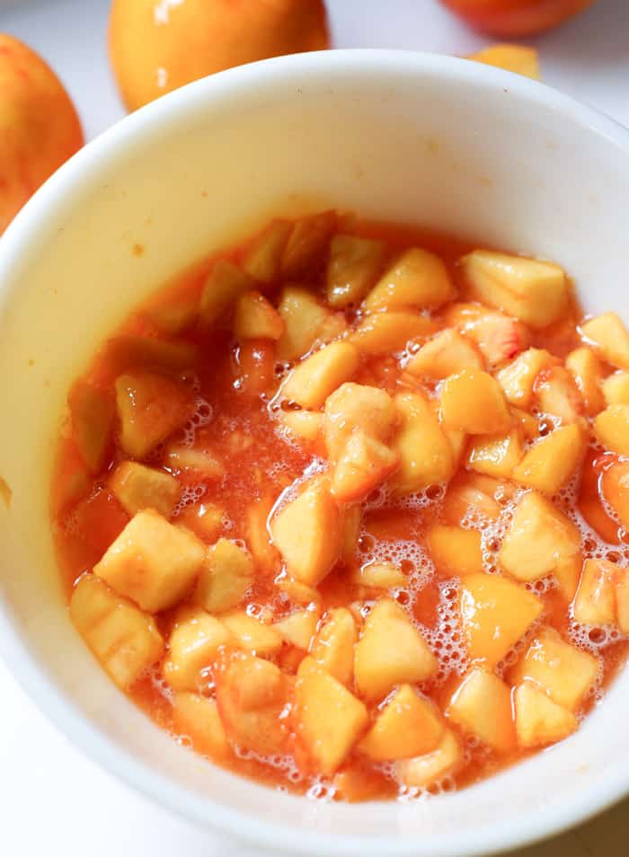 juices with peaches in bowl for peach pie