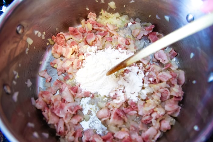 bacon in pan with milk for chowder recipe