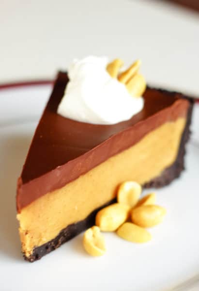 chocolate peanut butter pie on plate with nuts