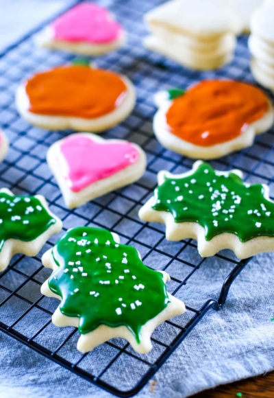 sugar cookies with icing on cooling rack