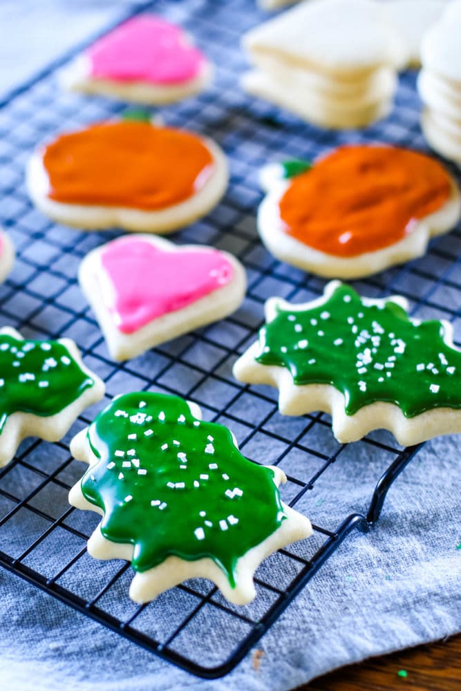 sugar cookies with icing on cooling rack