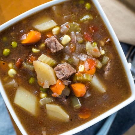 easy slow cooker vegetable beef soup in bowl with spoon
