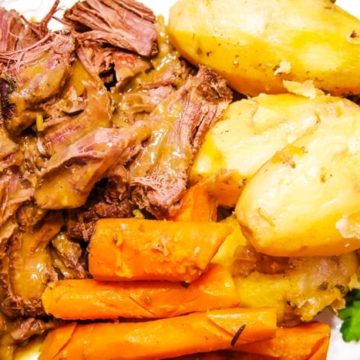 plate of venison roast deer roast with carrots and potatoes