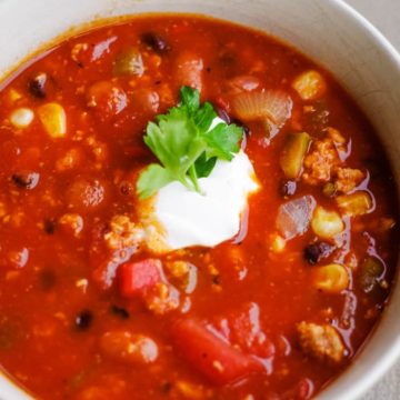 healthy turkey chili in bowl with sour cream