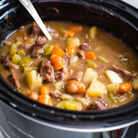 slow cooker beef stew with spoon