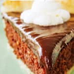 chocolate coconut pie on plate with whipped cream on top