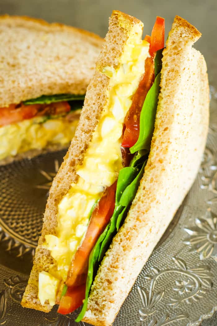 egg salad sandwich with lettuce and tomato