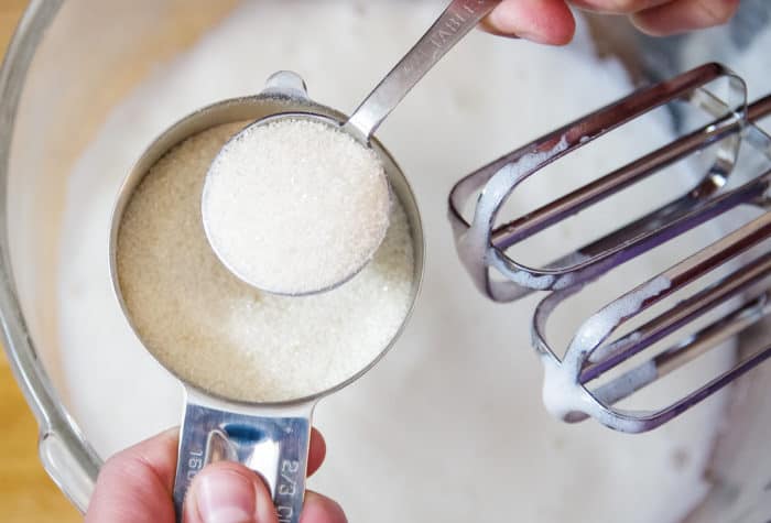 adding sugar to foamy egg whites for meringue cookies