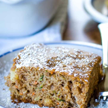 zucchini cake slice on plate with fork