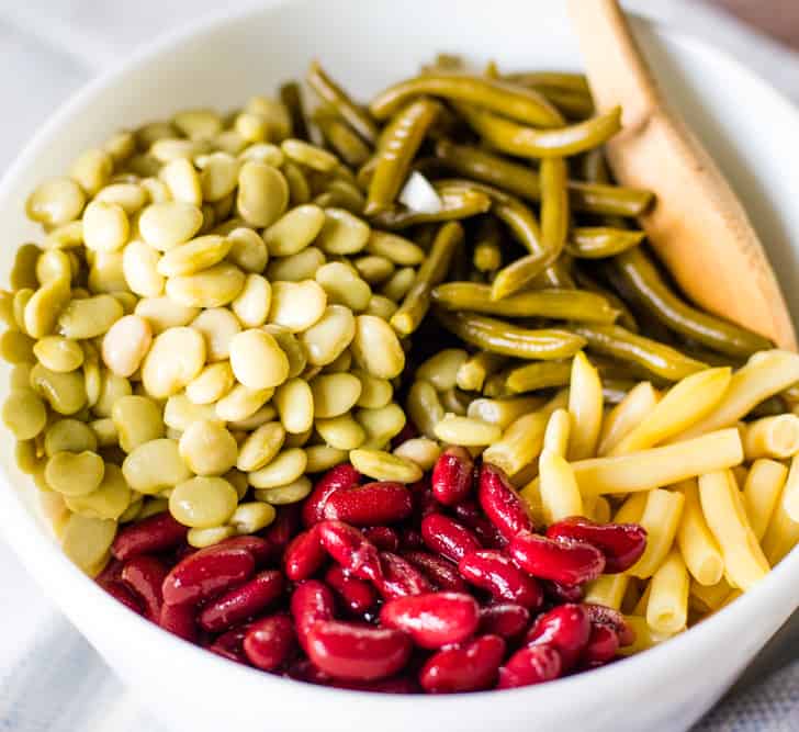 yellow string beans, green string beans, dark kidney beans and lima beans in bowl