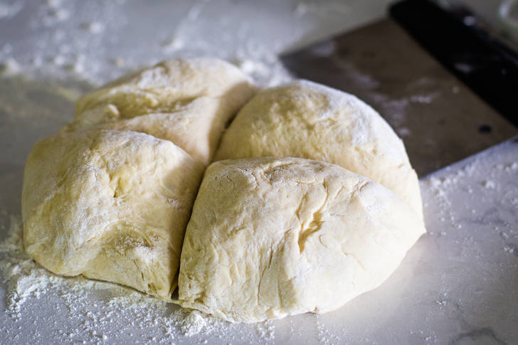 pizza dough divided into four